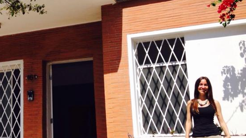 Ilaina standing in front of the Amani house in Nairobi