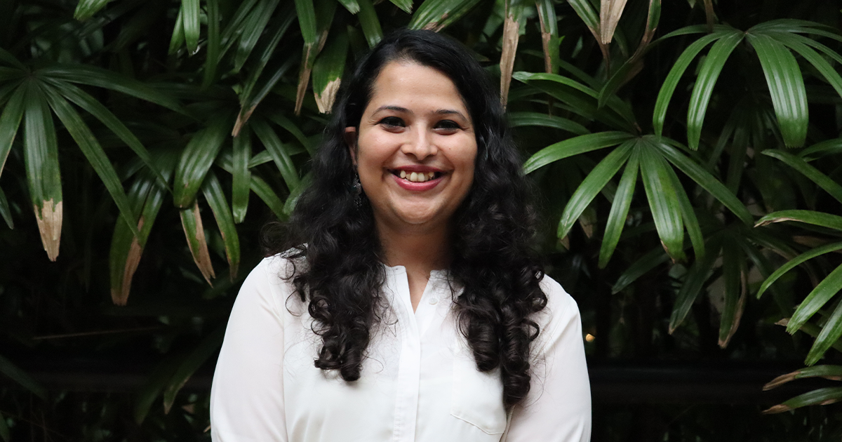 Headshot Shehzia with green leaves in the background