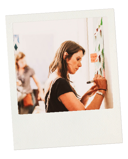 Polaroid picture of woman writing on post it